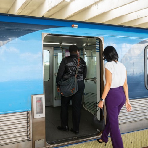 woman getting on train