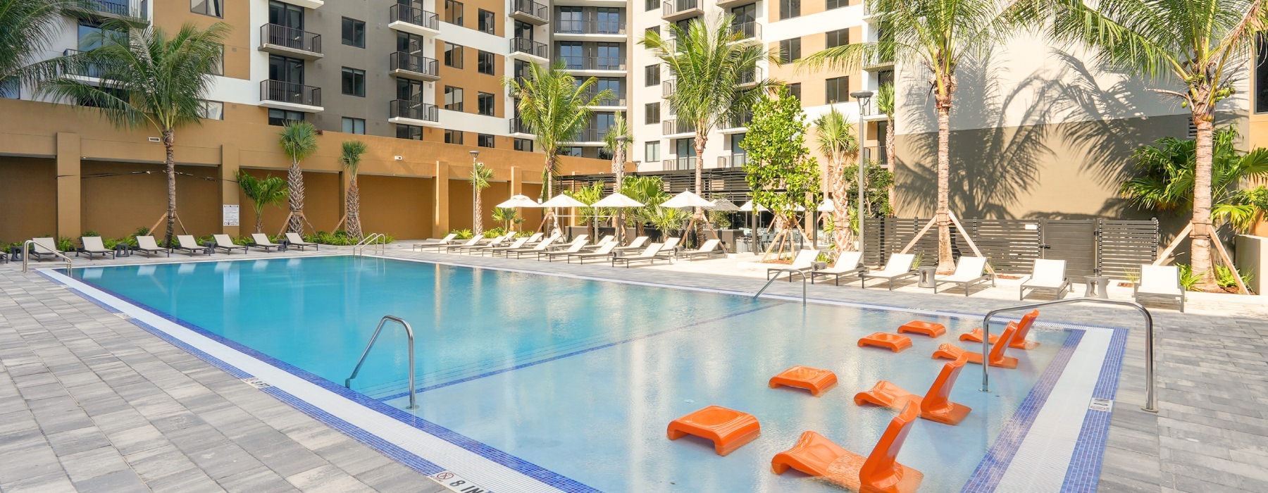 Resort-style swimming pool with lounge seating